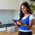 A lady looking at her tablet to help her organise her day