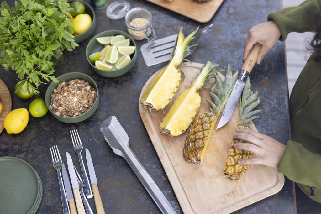 Opinel Barbecue set on a table with a slcied pineapple