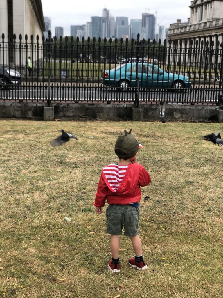 Young boy in Greenwich looking over to the city of London