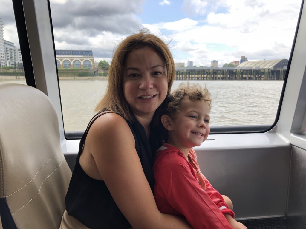 Mum and son on a TFL river boar from Grenwich to London