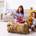 Mum and daughter at home packing a bag for a family festival