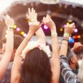 Back of the crowd at a UK Festival with the crowd having their hands in the air