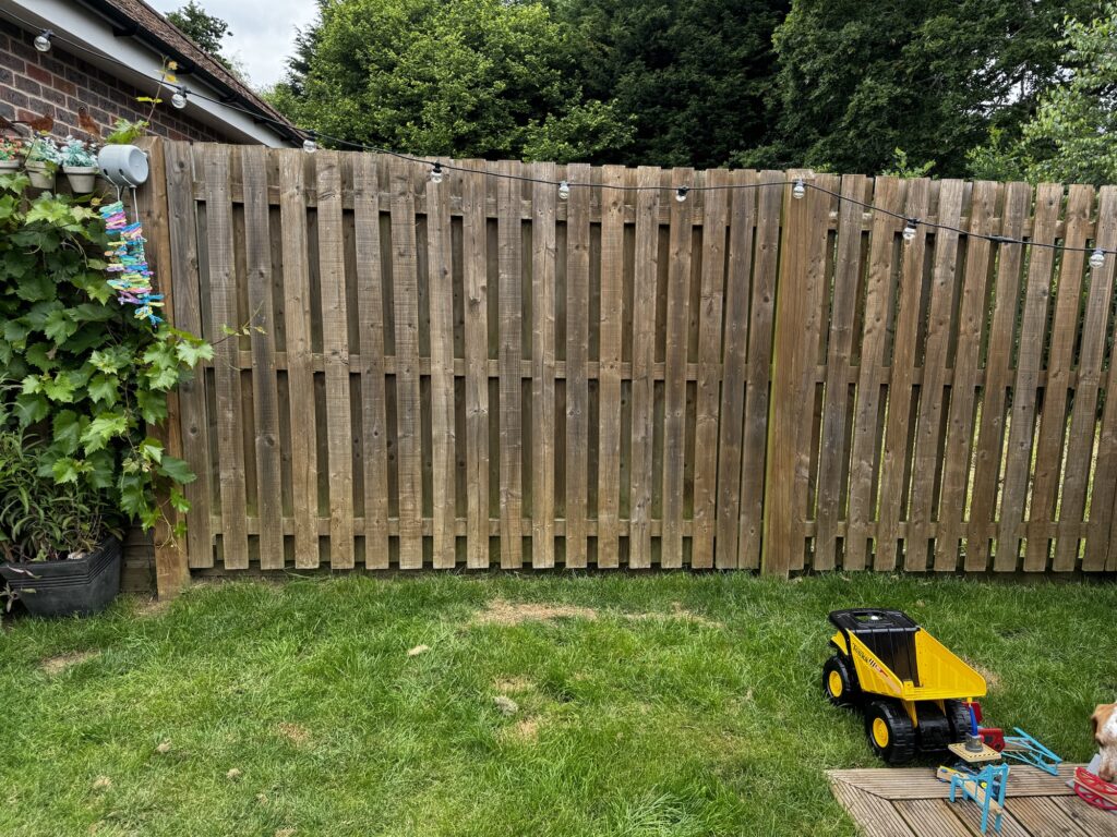 Back garden with grass and fence