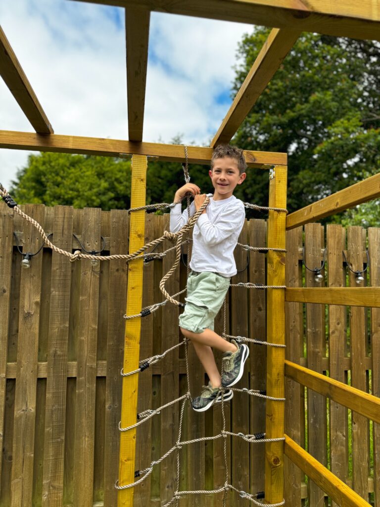 Boy on his Wickey Climbing Tower rope ladder