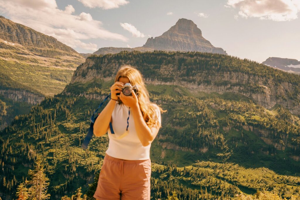 Woman taking photo West Glacier, MT, USA