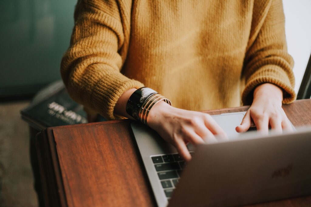 Working mum on laptop with stylish bangle