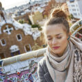 Woman in Barcelona with scarf and headphones.