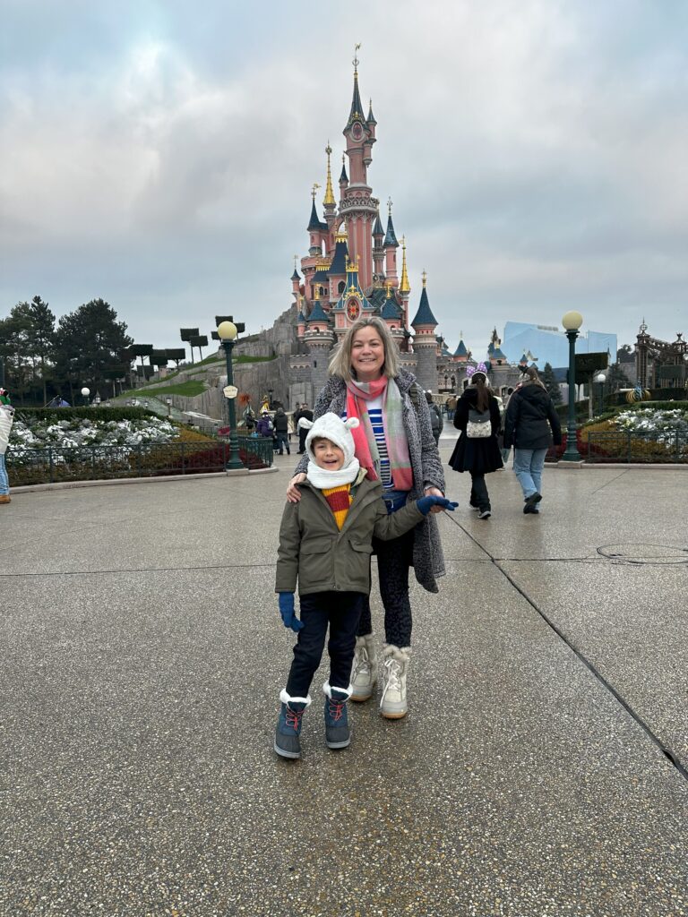 Mum and son at Disneyland Paris in the winter wearing warm clothes