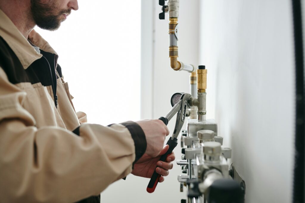Plumber installs pipe fittings