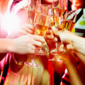 Champagne glasses together as people cheers each other
