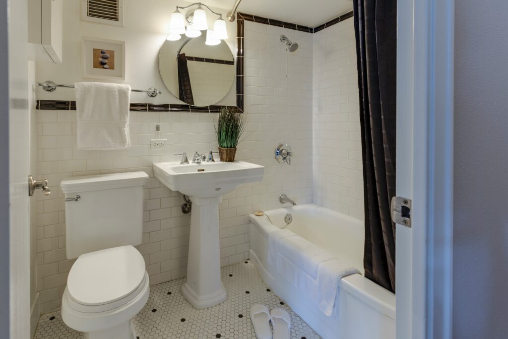 white bathroom with balck shower curatin