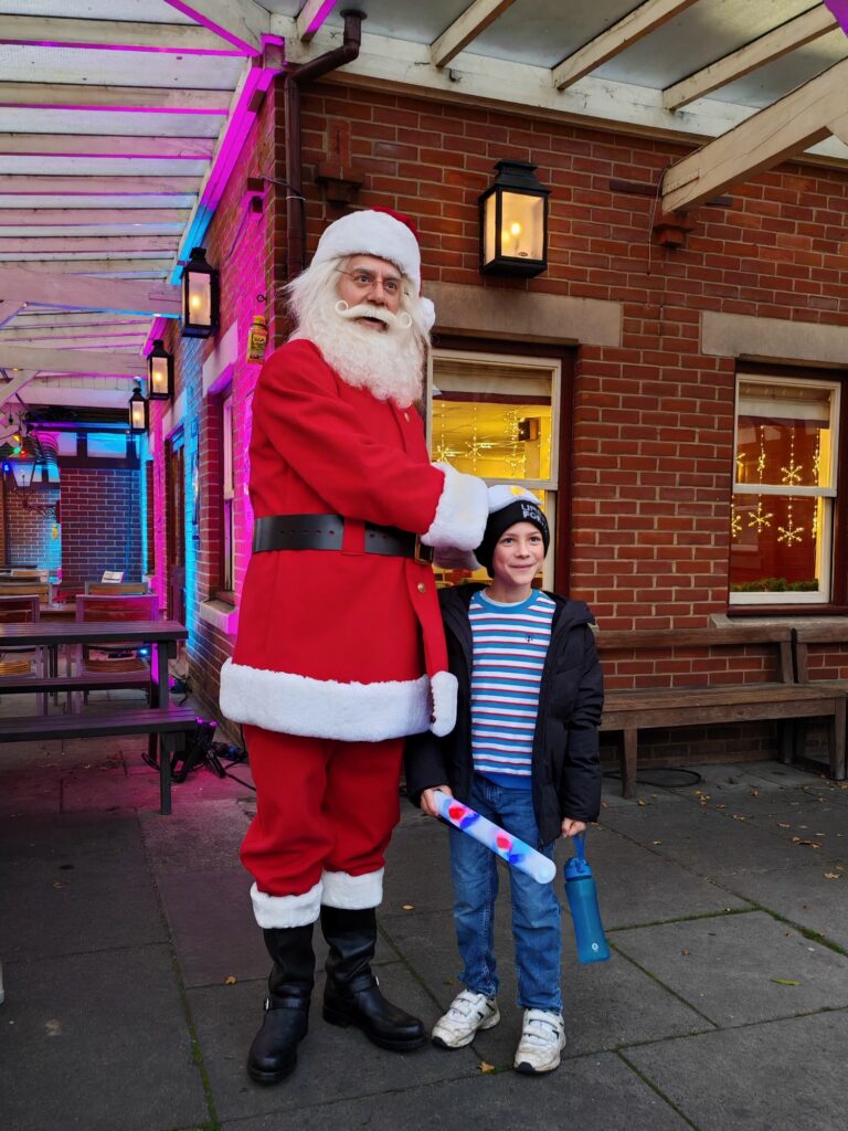 Boy meeting Santa Clause on the platfrom of Sheffiled Park Train Station