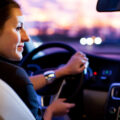 Woman driving car at night