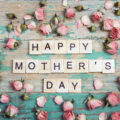 Letters spelling put Happy Mother's Day surrounded by rose buds