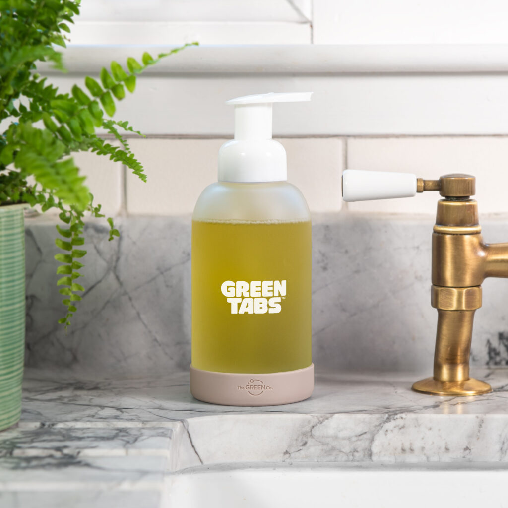 Refillable hand soap in a glass pottle by the bathroom sink