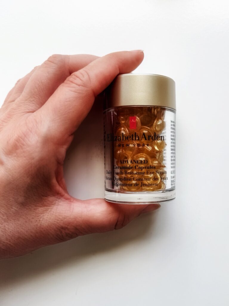 Hand holding the bottle containing Elizabeth Arden Advanced Ceramide Capsules Daily Youth Restoring Eye Serum