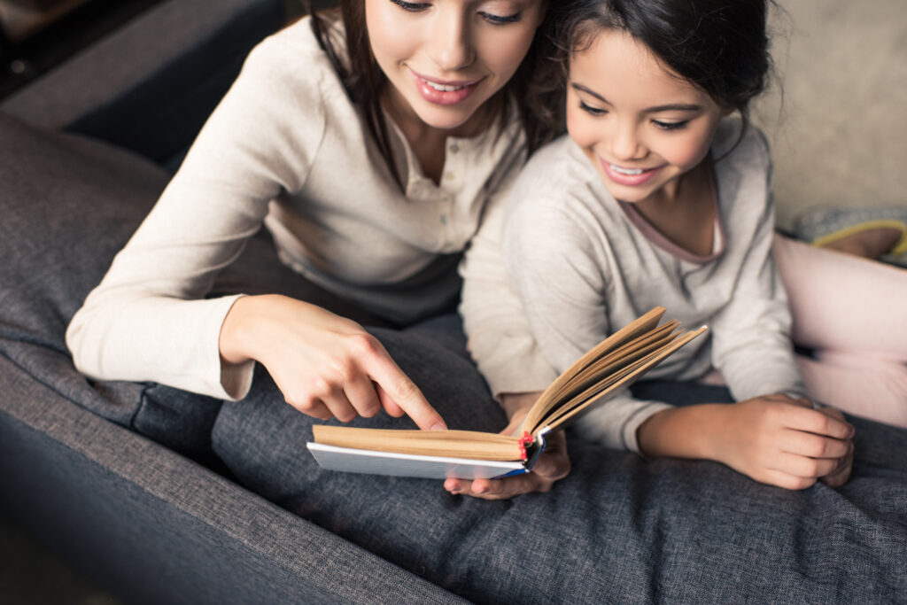 Mum and daughter looking at a book together