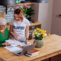 Woman volunteering to help an elderly woman in her home