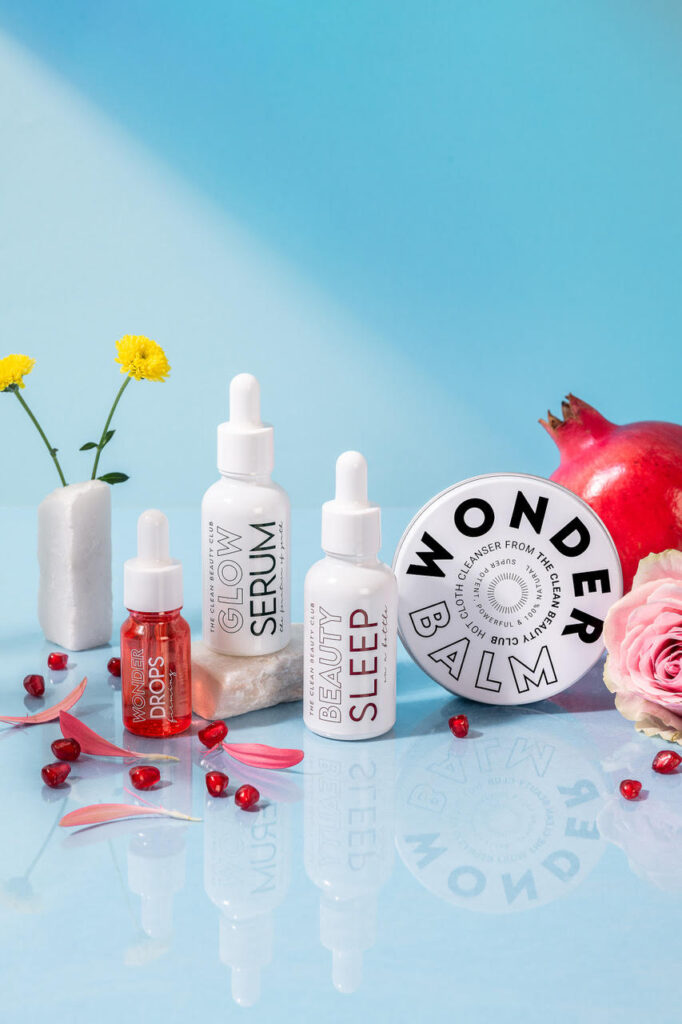 Skincare products from the clean beauty club flat lay with blue background