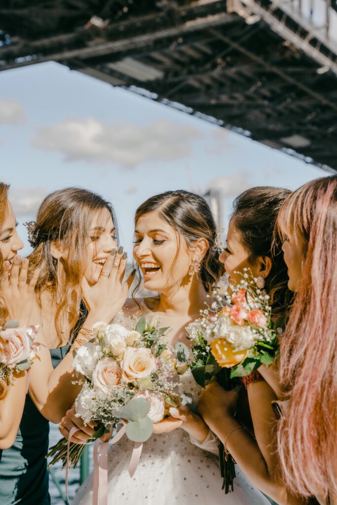 Happy bride surrounded by her bridesmaids