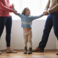 Divorced parents pulling child in their own direction