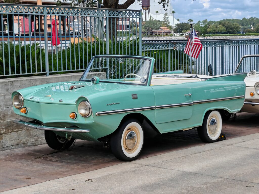 A turquise amphica parked up outside the boathouse at Disney Springs