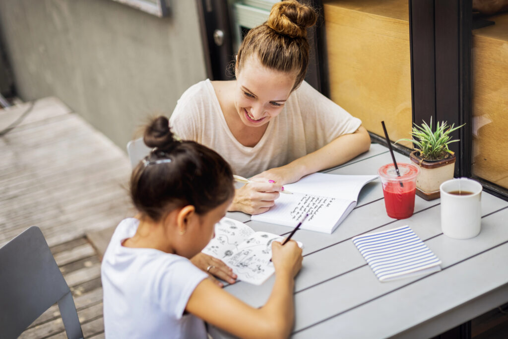 Young tutor helping girl with her studies