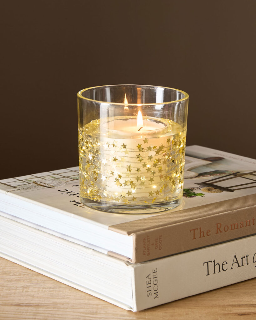 Light up star candle on pile of books