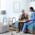 In home care with nurse and elderly lady in her living room