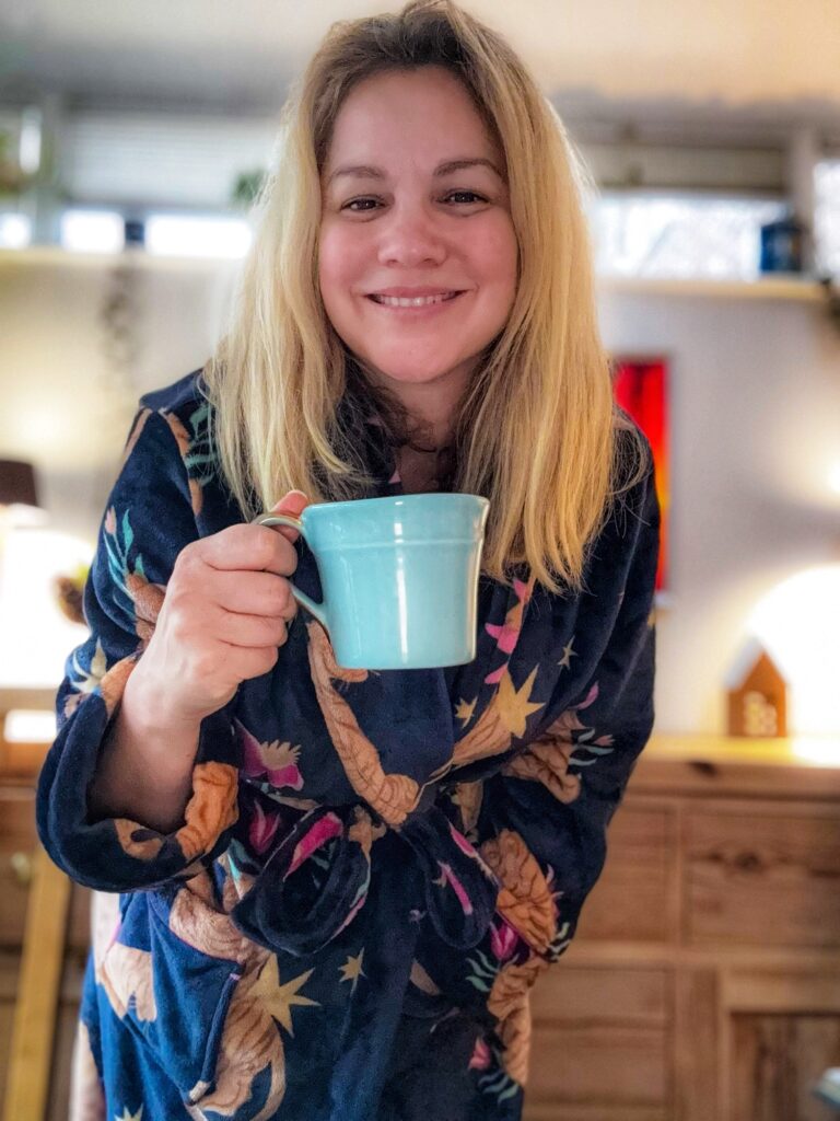 Woman in dressing gown with mug of coffee