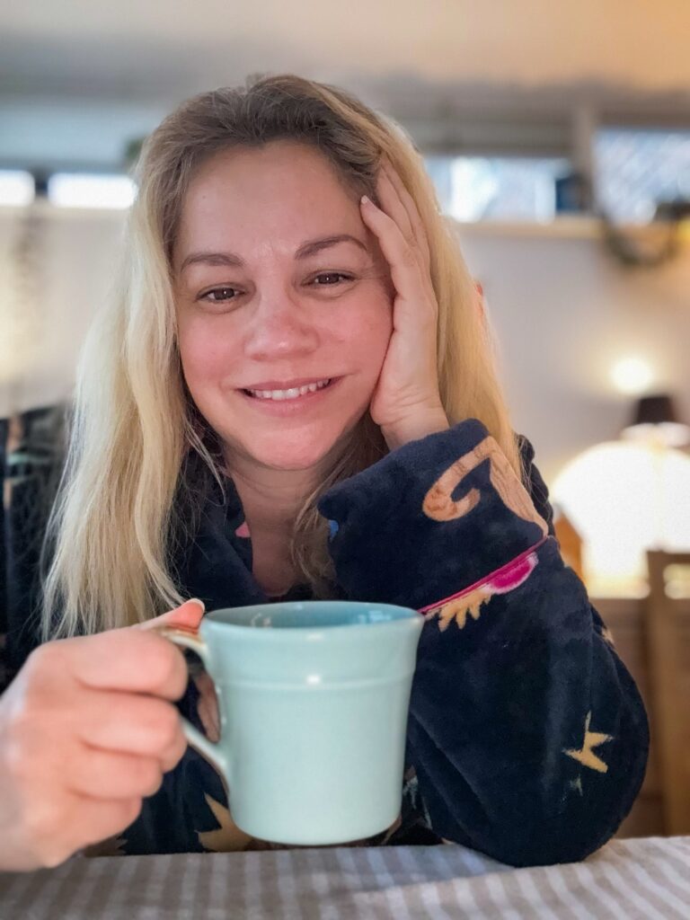 Woman with a mug of tea in cosy winter home setting