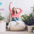 Lady relaxing on bean bags in her home surrounded by lovely green plants