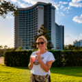 Happy smiling lady outside the Drury Plaza hotel Disney Springs area with her free kick back cocktail
