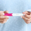 lady's hands holding a pregnancy test