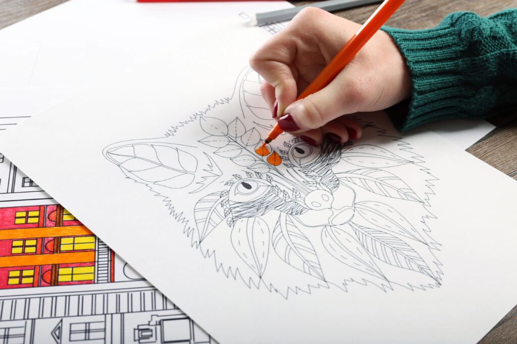 Female hand colouring in an animal picture