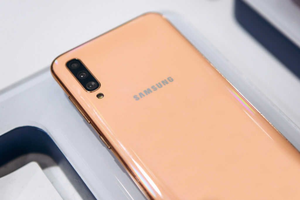 Close up of back of a peach samsung mobile phone