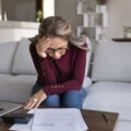 Woman looking stressed and worried over her bills