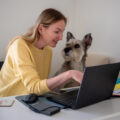 Woman working from home with her dog