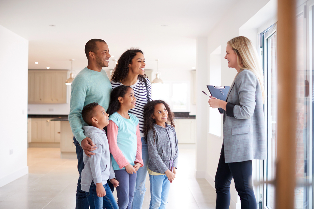Family with an estate agent viewing a house to see if it would make a great new home