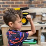 Boy showing how tough TONKA trucks are